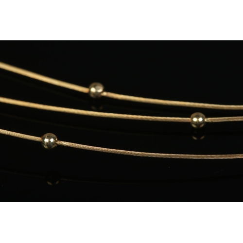 213 - A 9ct gold three band necklace with ball decoration. Makers stamp IBB. 4.04g.