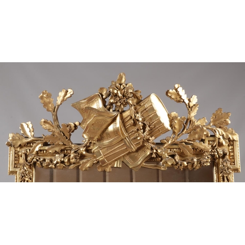 230 - A large 19th century gilt framed pier mirror. Surmounted with music sheets, drum, acanthus leaves an... 