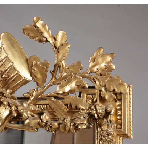 230 - A large 19th century gilt framed pier mirror. Surmounted with music sheets, drum, acanthus leaves an... 