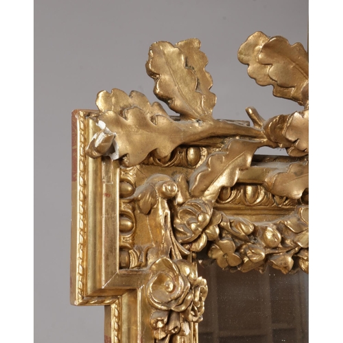230 - A large 19th century gilt framed pier mirror. Surmounted with music sheets, drum, acanthus leaves an... 
