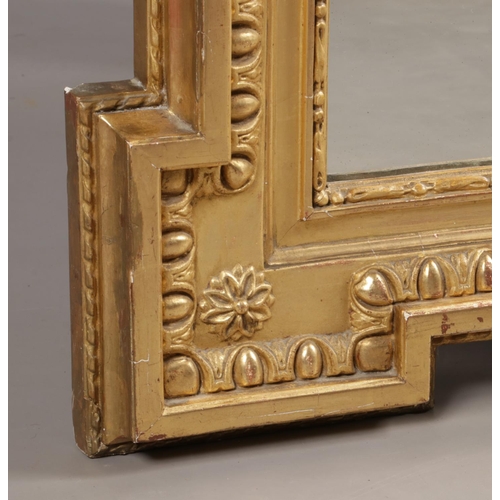 230 - A large 19th century gilt framed pier mirror. Surmounted with music sheets, drum, acanthus leaves an... 