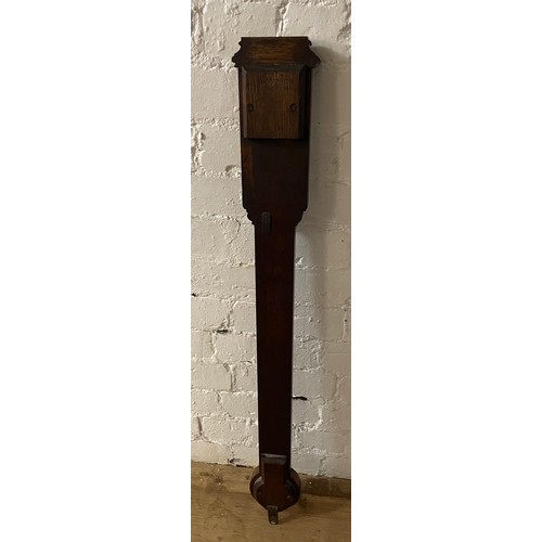 216 - An oak stick barometer by FL West. Length 97cm.