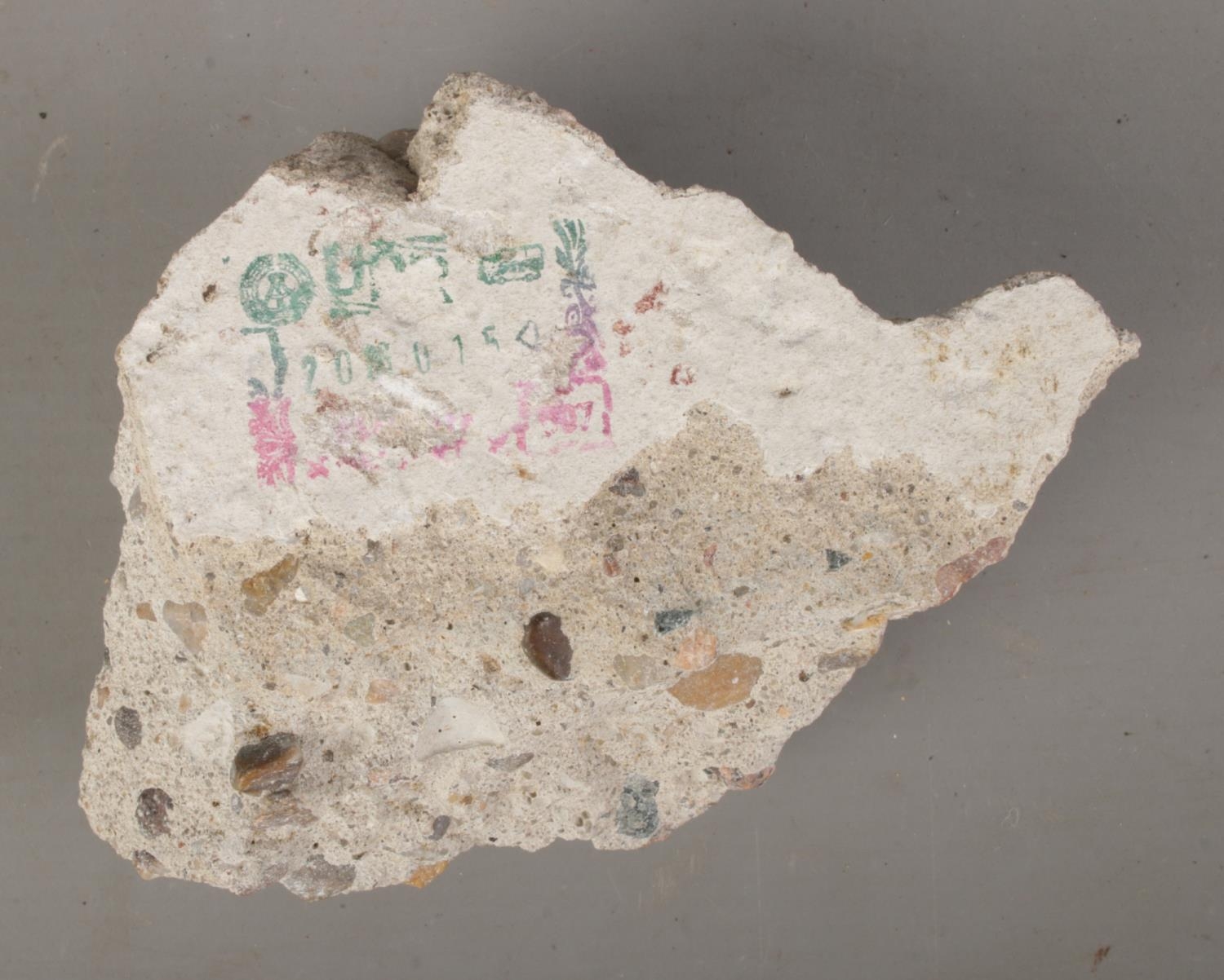 A concrete fragment purportedly from the Berlin Wall, Germany. Features ...