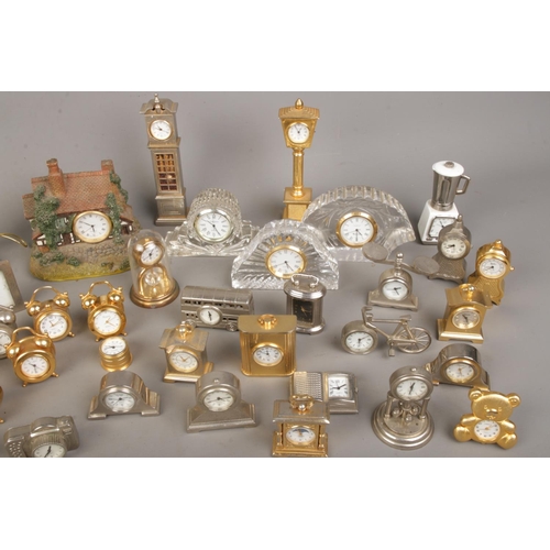 A large collection of miniature novelty clocks to include some modelled ...