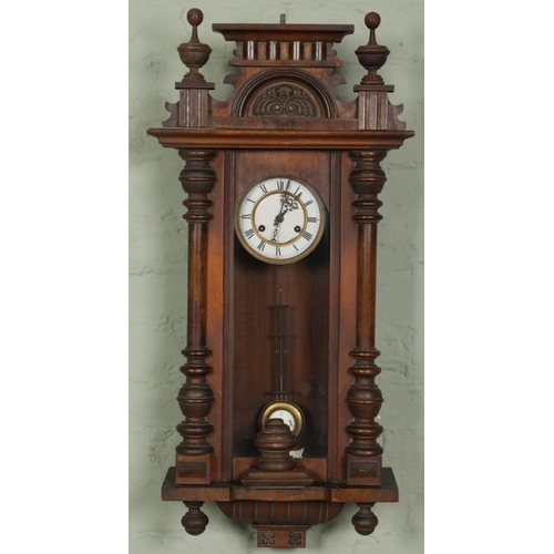An antique German mahogany spring driven vienna wall clock with carved ...