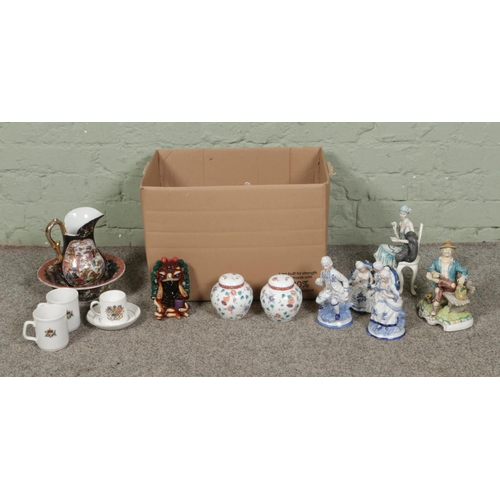 122 - A box of assorted items, to include onyx bodied Aztec warrior figure, a quantity of figures produced... 