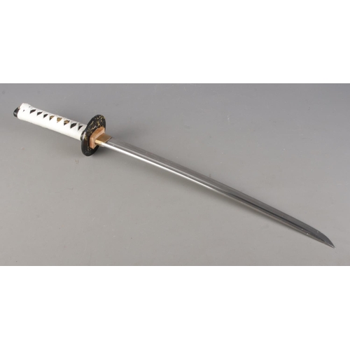 76 - A modern samurai sword in sheath mounted on stand, together with a set of nunchucks. Blade length of... 