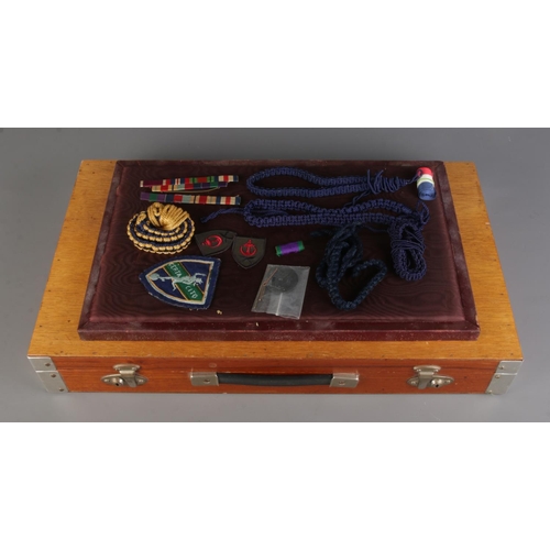 A collection of military related items in a display travel case; Two ...