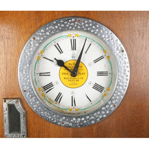 2 - An oak cased 1930's Bryan's 'Sixwin' clock penny arcade spinning game, with ebonised top panel. Stam... 