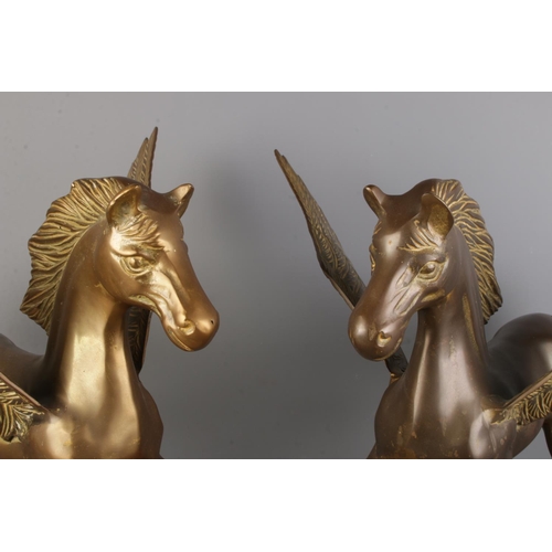 23 - A pair of brass Pegasus on shaped bases. Height: 46cm, Width: 43cm.