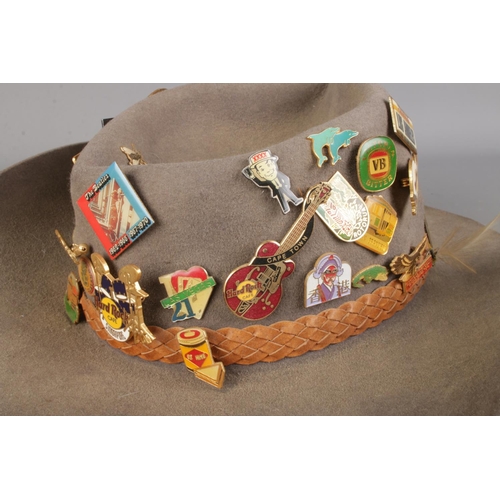 95 - An Australian Outback bush hat featuring a collection of assorted pin badges to include several Hard... 
