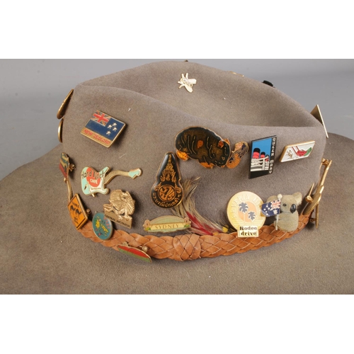 95 - An Australian Outback bush hat featuring a collection of assorted pin badges to include several Hard... 