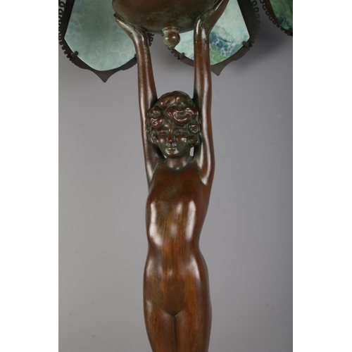 1 - An Art Deco style figural bronze table tamp with tiffany style shade; Featuring nude lady holding tu... 