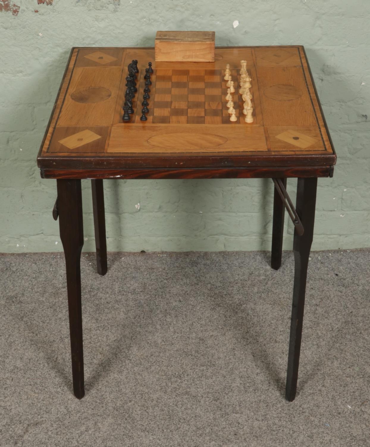 A marquetry inlaid folding games tables and complete chess set ...