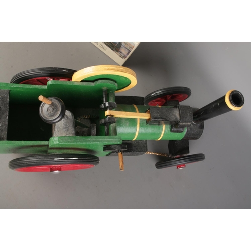 96 - An apprentice small wooden handcrafted painted train model  alongside three boxed Airfix train model... 