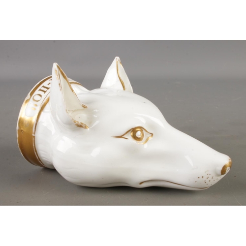 A 19th century porcelain stirrup cup in the form of a foxes head with gilt collar and 'Tally-Ho!!' inscribed along the collar 

10.5cm long