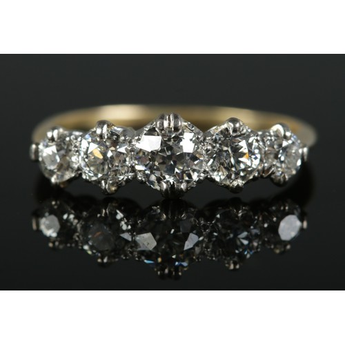 A gold five stone diamond ring. Central diamond approximately 0.75ct. Size R. 2.39g.