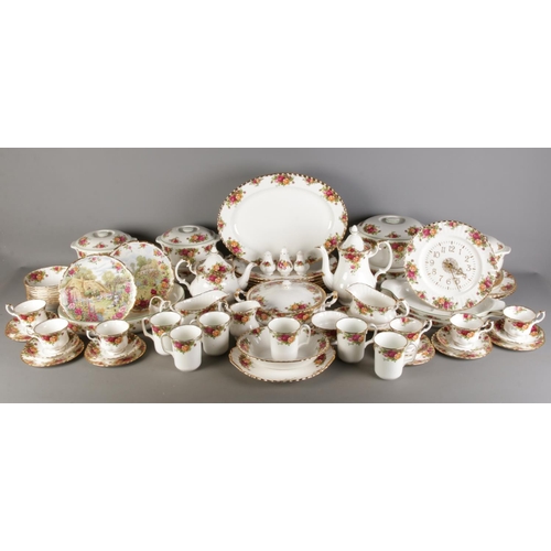A very large collection of Royal Albert Old Country Roses ceramics, including lidded tureens, dinner plates, oval plates, cup and saucers, clock, Country Bakeware, teapot and coffee pot, milk jug and sugar bowl etc. To also included placemats, coasters and similar spoons and fork. Approximately 83 pieces.