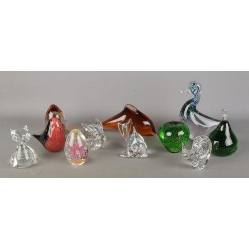 A collection of glass paperweights, including animal, fruit and dolphin ...