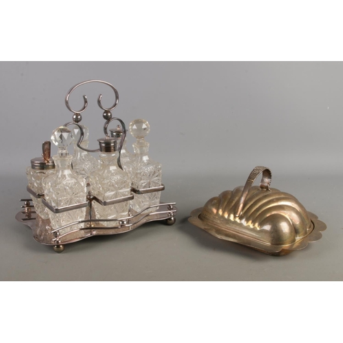 124 - A silver plated cruet set, housing glass bottles, shakers and mustard pot, together with a silver pl... 