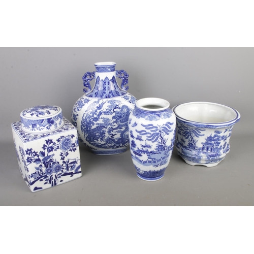265 - A collection of oriental blue and white ceramics to include Moon vase and Willow pattern examples.