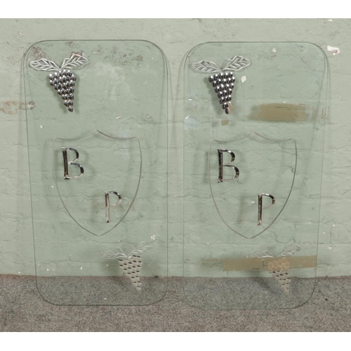 314 - Two glass panels marked for BP in central crest, surrounded by grape bunches. Approx. dimensions 86.... 