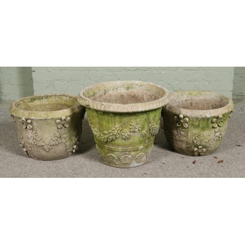 380 - A pair of composition stone garden planters with another larger similar