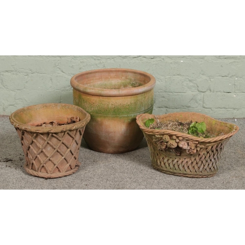 384 - Three terracotta planters of different forms including a basket example