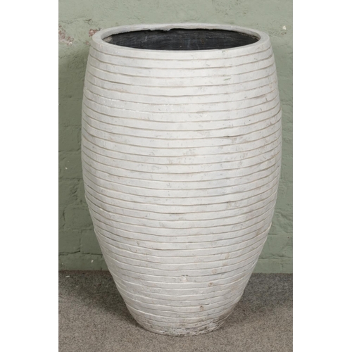 390 - A large ribbed white garden planter. H86cm