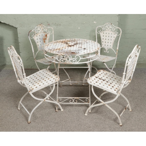 391 - A white wrought iron folding garden bistro table and four chairs. D68cm.