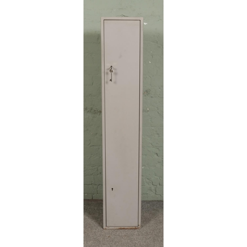 393 - A steel two section gun cabinet, with ACE locks. Height: 151cm, Width: 28cm, Depth: 25cm.