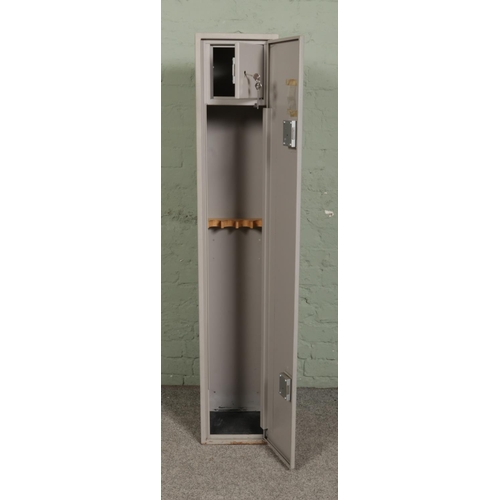 393 - A steel two section gun cabinet, with ACE locks. Height: 151cm, Width: 28cm, Depth: 25cm.