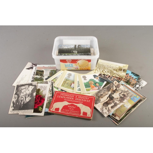 71 - A box of assorted vintage postcards; Mainly scenic landmark examples and a French postacrd album con... 