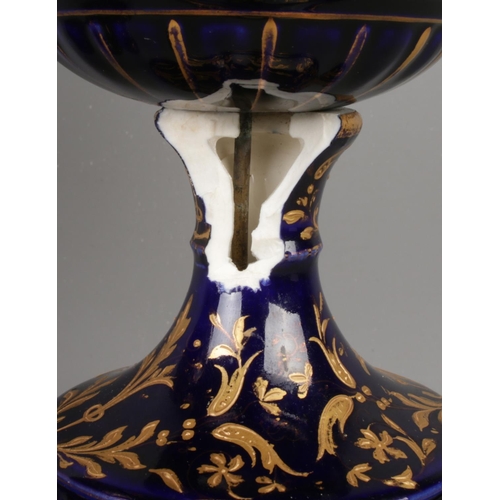 489 - A pair of early Twentieth Century Austrian twin handled lidded urns, in cobalt blue with gilt highli... 