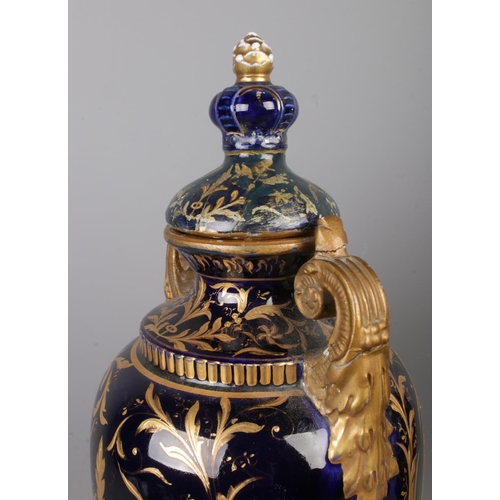 489 - A pair of early Twentieth Century Austrian twin handled lidded urns, in cobalt blue with gilt highli... 
