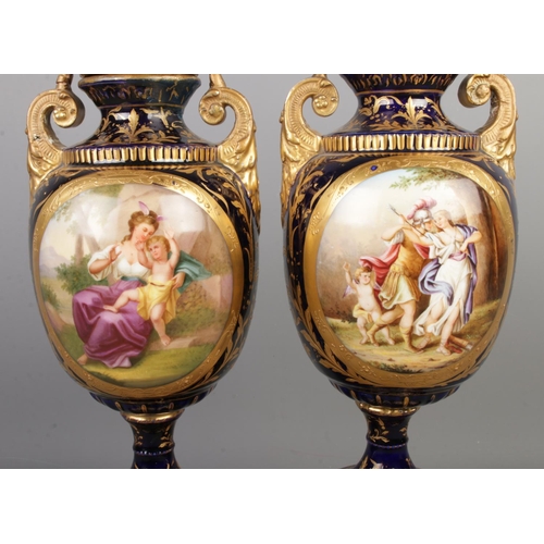 489 - A pair of early Twentieth Century Austrian twin handled lidded urns, in cobalt blue with gilt highli... 