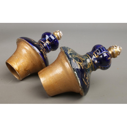 489 - A pair of early Twentieth Century Austrian twin handled lidded urns, in cobalt blue with gilt highli... 