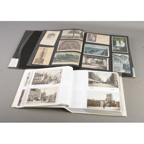 76 - Two albums of postcards containing antique and vintage examples including architectural and landscap... 