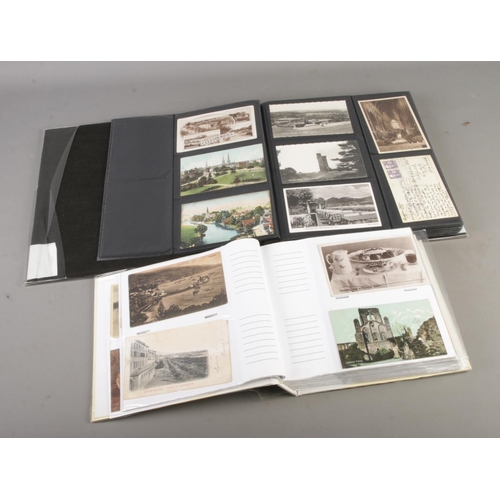 76 - Two albums of postcards containing antique and vintage examples including architectural and landscap... 