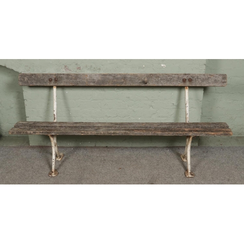544 - A white painted cast iron garden bench - stamped C Seward Preston with wooden seating.  L183cm.