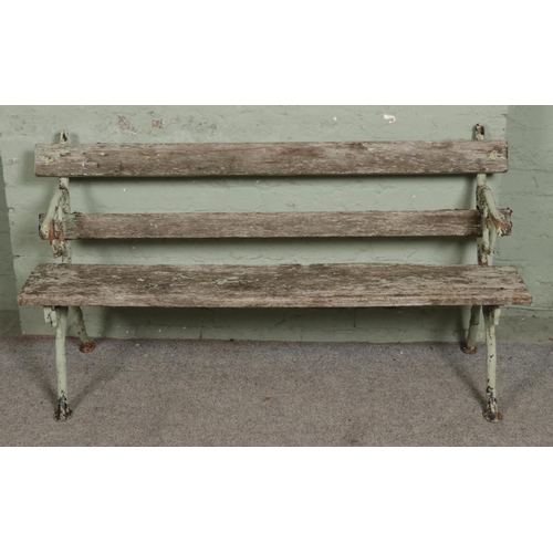 545 - A painted cast iron garden bench with branch-style frame and arms. L153cm.