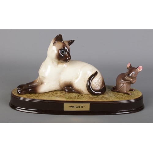 9 - A Beswick laying Siamese cat and mouse on Beswick stand 'Watch It'.