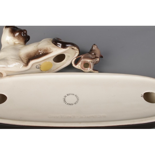 9 - A Beswick laying Siamese cat and mouse on Beswick stand 'Watch It'.