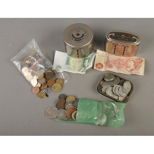 98 - A collection of assorted world coins along with two home penny bank to include Barclays Bank Home Sa... 