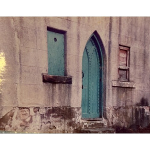 499 - An antique pine Gothic arched door featuring ironmongery studs and detailing with handles, locks etc... 