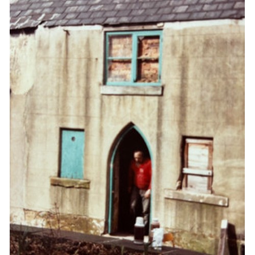 499 - An antique pine Gothic arched door featuring ironmongery studs and detailing with handles, locks etc... 