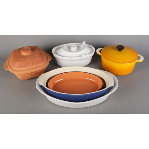 166 - A collection of kitchenware; An orange Descoware Belgium casserole lidded pot alongside a Romertopf ... 