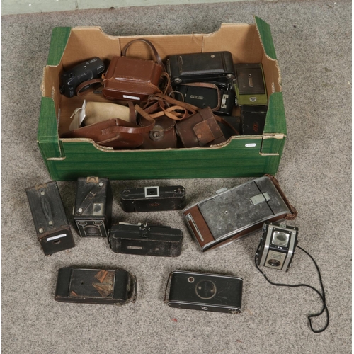124 - A box of assorted vintage cameras to include Kodak Brownies, Olympus, Ensign, Polaroid, etc.