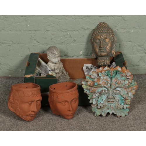 135 - Two Rookes Pottery terracotta wall planters in the shape of heads alongside three garden ornaments i... 
