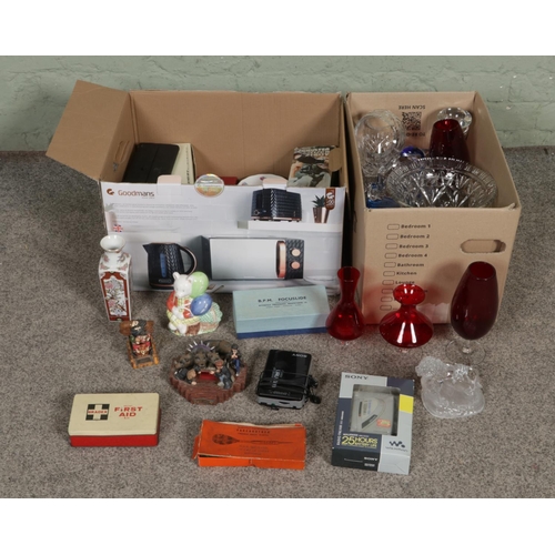 160 - Two boxes of miscellaneous to include assorted glassware, Sony Walkman players, Harry Potter figures... 